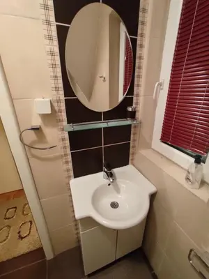 a bathroom with a white sink and a mirror at Apartman Sofija Kraljevi Čardaci in Kopaonik