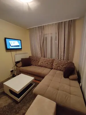 a living room with a couch and a flat screen tv at Apartman Sofija Kraljevi Čardaci in Kopaonik