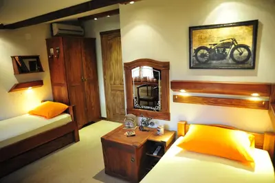 a bedroom with two beds and a mirror and a tv at B&B Galerija Two Rooms in Paraćin