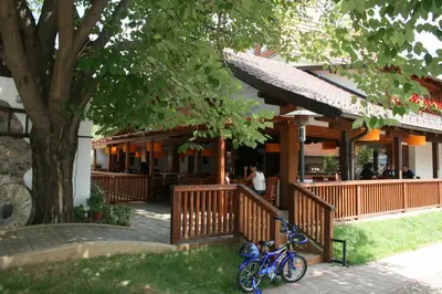 a blue bike parked in front of a restaurant at B&B Galerija Two Rooms in Paraćin