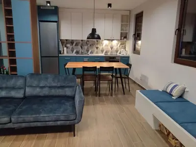 a living room with a couch and a table at FlowHouse - cozy place for you. in Kopaonik