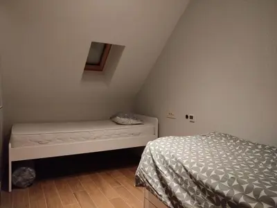 a small bedroom with a bed and a small window at FlowHouse - cozy place for you. in Kopaonik