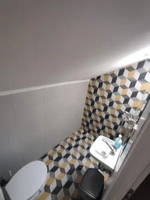a bathroom with a toilet and a sink at Apartmani Hub in Niš