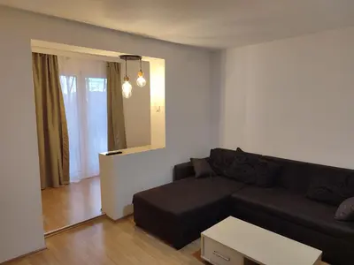 a living room with a couch and a table at Apartmani Hub in Niš