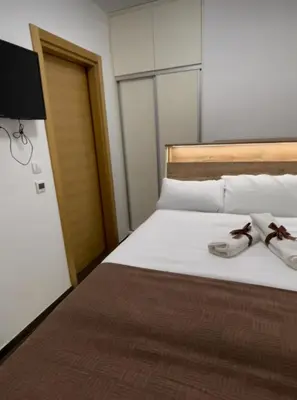 a bedroom with a bed with two shoes on it at SKY PEAK KRALJEVI ČARDACI APARTMENT in Kopaonik
