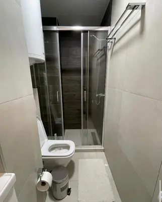 a bathroom with a toilet and a glass shower at SKY PEAK KRALJEVI ČARDACI APARTMENT in Kopaonik