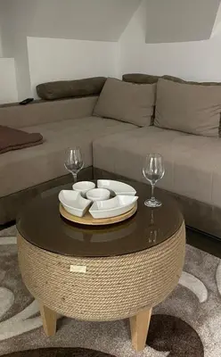 a living room with a couch and a table with wine glasses at SKY PEAK KRALJEVI ČARDACI APARTMENT in Kopaonik