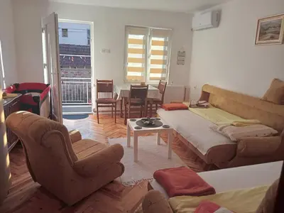 a living room with a couch and a table and chairs at Apartman Nedeljković in Vrnjačka Banja