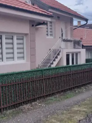 a house with a fence in front of it at Apartman Nedeljković in Vrnjačka Banja