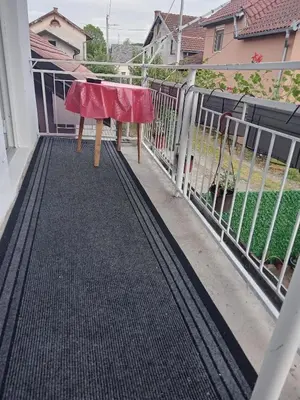 a table on the balcony of a house at Apartman Nedeljković in Vrnjačka Banja