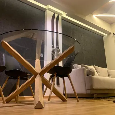 a glass table in a living room with a couch at Apartman Kiš Kraljevi Čardaci in Kopaonik