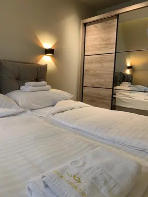 a bedroom with two beds and a large closet at Apartman Kiš Kraljevi Čardaci in Kopaonik