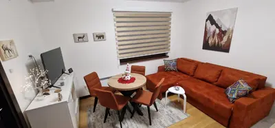 a living room with a couch and a table at Glečer Kop A11 FREE Parking Garage in Kopaonik