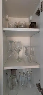 a shelf filled with clear glass wine glasses at Glečer Kop A11 FREE Parking Garage in Kopaonik