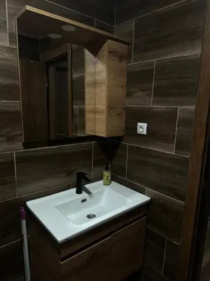 a bathroom with a sink and a mirror at Apartment KopaLux in Kopaonik