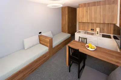 a room with two beds and a table with a bowl of bananas on it at Studio Joanna Vila Bela Reka in Brzeće