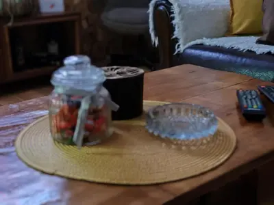 a table with a jar of fruit and a remote control at Vila Antić in Pirot