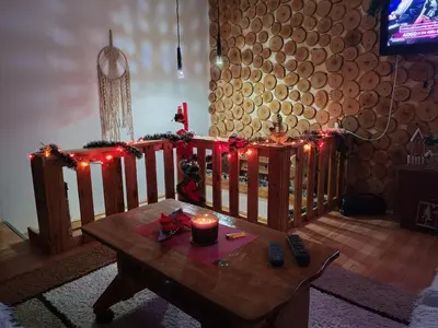 a room with a table with a candle and christmas lights at Vila Antić in Pirot