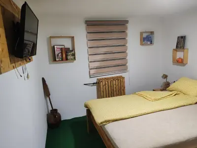 a bedroom with a bed and a flat screen tv at Vila Antić in Pirot