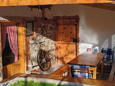 a wooden room with a wooden table and a wheel at Vila Antić in Pirot