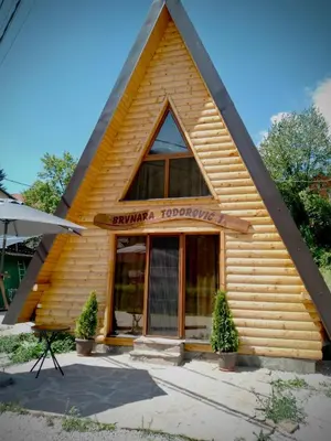 a log building with a sign on it at Brvnare Todorovic in Crni Vrh