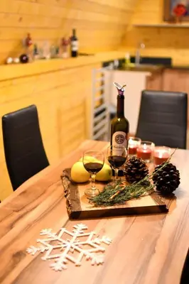 a table with a bottle of wine and two glasses at Brvnare Todorovic in Crni Vrh