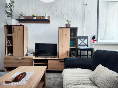 a living room with a couch and a tv at Milano Apartman **** in Brzeće