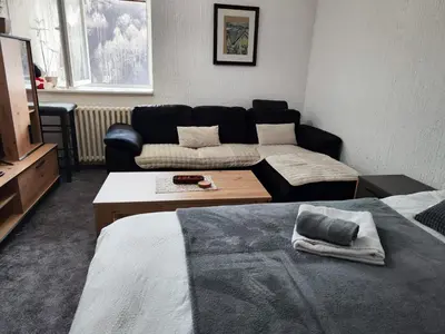 a living room with a couch and a living room at Milano Apartman **** in Brzeće