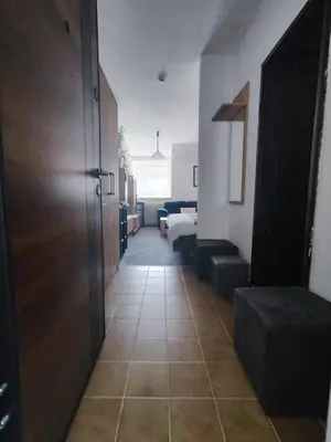 a hallway with a door and a room at Milano Apartman **** in Brzeće