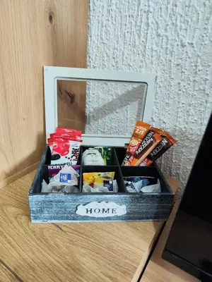 a box filled with various snacks on a table at Milano Apartman **** in Brzeće