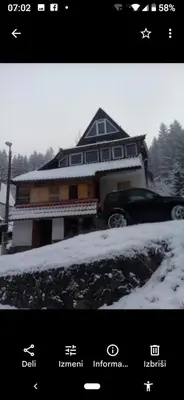 a house with a car parked in the snow at KopanikSkiRooms15e in Kopaonik