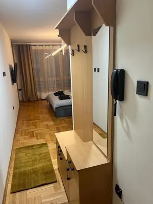 a bathroom with a mirror and a bed in a room at LP Premium Studio in Niš