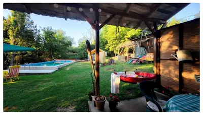 a backyard with a table and a swimming pool at Zvezdano nebo in Svrljig