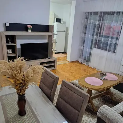 a living room with a couch and a table at Apartman Magic in Soko Banja