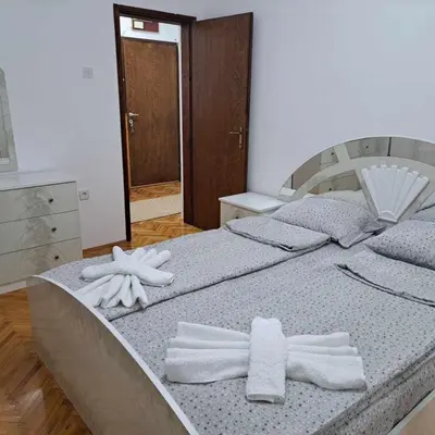 a bedroom with two beds with towels on them at Apartman Magic in Soko Banja