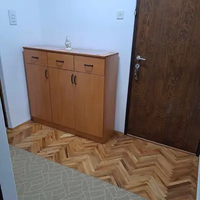 a wooden cabinet in a room next to a door at Apartman Magic in Soko Banja