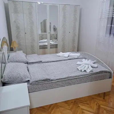 a bedroom with a bed with towels on it at Apartman Magic in Soko Banja