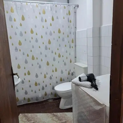 a bathroom with a toilet and a shower curtain at Apartman Magic in Soko Banja