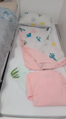 a bed with pink and white sheets and pillows at Crnjanski Paun L in Jagodina
