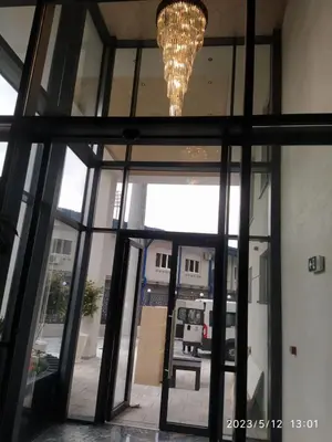 a glass door with a chandelier in a room at Crnjanski Paun L in Jagodina