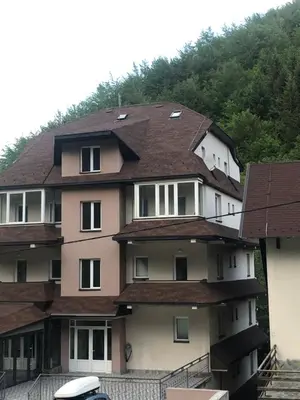 a building with a roof on top of it at LOVE apartman JeLEna in Brzeće
