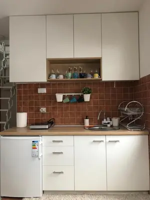 a kitchen with white cabinets and a sink at LOVE apartman JeLEna in Brzeće