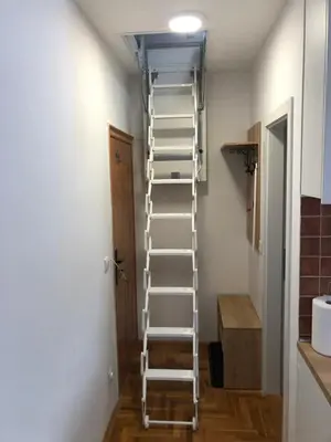 a ladder in a room next to a door at LOVE apartman JeLEna in Brzeće