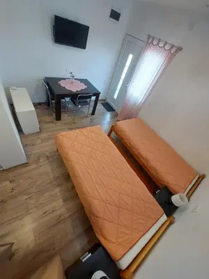an overhead view of a room with two beds and a table at Apartmani Popović in Knjazevac.