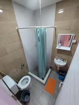 a bathroom with a shower and a toilet and a sink at Apartmani Popović in Knjazevac.