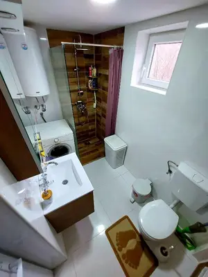 a bathroom with a sink and a toilet and a shower at Apartmani Popović in Knjazevac.
