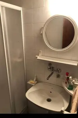 a small bathroom with a sink and a mirror at Apartman Ema,Bela Reka,Brzece in Brzeće