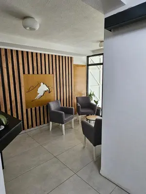 a waiting room with chairs and a table at Studio Leone Sunčana Planina in Kopaonik