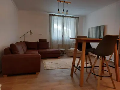 a living room with a couch and a table at Studio Leone Sunčana Planina in Kopaonik