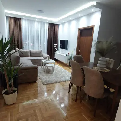 a living room with a couch and a table at Apartman Zapadni Kej M&M in Pirot
